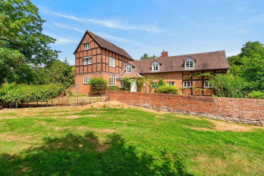 Priors Court, a Grade II Listed country house in Aylton, Herefordshire, viewed across its garden