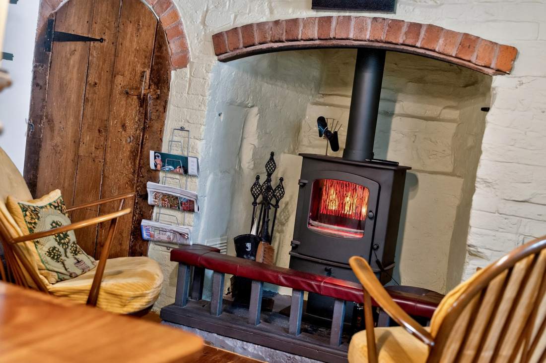 A wood-burning stove in one of the reception rooms at Priors Court, Aylton