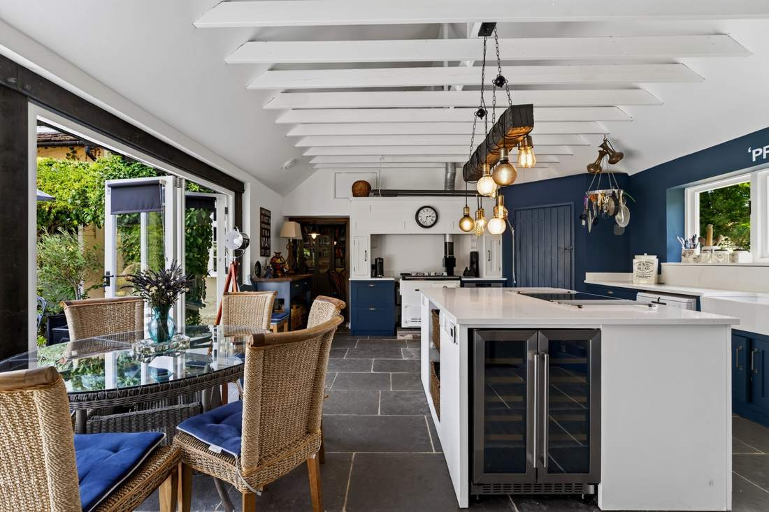 The kitchen at Priors Court, Aylton, opening onto the garden through bifold doors