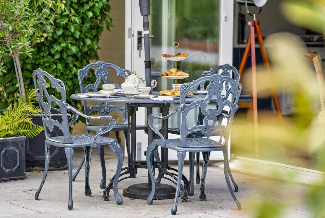 Afternoon tea laid out on the patio at Priors Court, Aylton, beside the kitchen's bifold doors