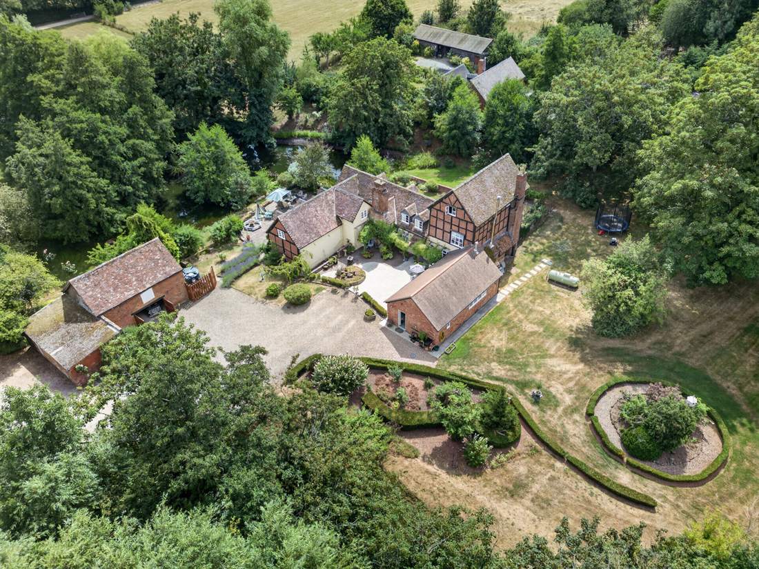 Aerial view of Priors Court, Aylton, showing the house, gardens and outbuildings